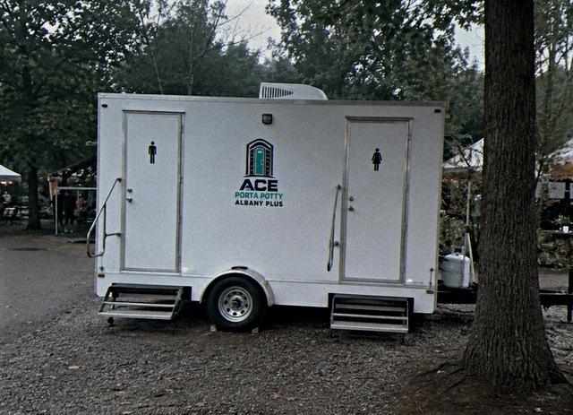 Two station restroom trailer rental set up at an outdoor event